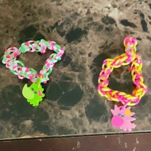 Dual of two bracelets with charms that are erasers